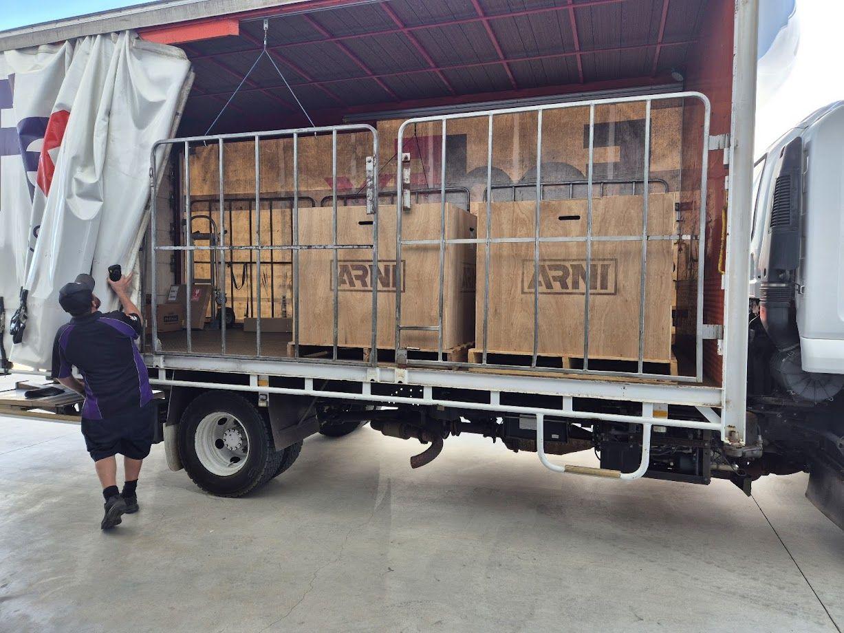 Image of ARNI units in timber crates on the back of a truck being unloaded in SA